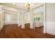 Open concept dining room with hardwood floors, white walls and a chandelier at 318 Liberty Ln, Canton, GA 30114