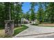 Brick mailbox and long driveway leading to a home in a wooded area at 318 Liberty Ln, Canton, GA 30114