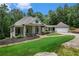 Green house with wraparound porch and attached garage; landscaped yard at 318 Liberty Ln, Canton, GA 30114