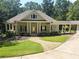 Suburban home with a large front porch and attached garage at 318 Liberty Ln, Canton, GA 30114