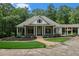 Green house with a large front porch and attached garage at 318 Liberty Ln, Canton, GA 30114