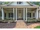 Front porch with white columns and stone pathway leading to front door at 318 Liberty Ln, Canton, GA 30114