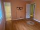 Main bedroom with wood-look flooring and access to bathroom at 5234 Maroney Mill Rd, Douglasville, GA 30134