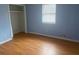 Bright bedroom with light blue walls and wood-look flooring at 5234 Maroney Mill Rd, Douglasville, GA 30134