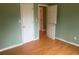 Bedroom with light green walls and wood-look flooring at 5234 Maroney Mill Rd, Douglasville, GA 30134