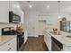 Modern kitchen with stainless steel appliances and white cabinets at 8231 Walnut Hall Dr, Fairburn, GA 30213