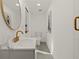 Stylish basement bathroom with white vanity, gold fixtures, and modern decor at 1639 Stokes Sw Ave, Atlanta, GA 30310