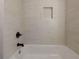 Clean bathroom with a bathtub and updated tile shower at 1639 Stokes Sw Ave, Atlanta, GA 30310