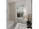 Modern bathroom with a bathtub, window, and updated fixtures at 1639 Stokes Sw Ave, Atlanta, GA 30310