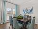 Dining room with hardwood floors and a dark wood table with blue chairs at 3201 Greyton Dr, Buford, GA 30519