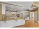 Updated kitchen boasts granite countertops and white cabinetry at 325 Yellowroot Ln, Sandy Springs, GA 30350