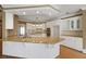 Modern kitchen with granite island and white cabinets at 325 Yellowroot Ln, Sandy Springs, GA 30350