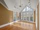 Bright sunroom with hardwood floors and wall-to-wall windows at 325 Yellowroot Ln, Sandy Springs, GA 30350