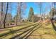 Spacious backyard with large grassy area and firepit at 531 Sweetfern Ln, Sugar Hill, GA 30518