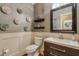 Powder room with decorative wall accents and modern vanity at 531 Sweetfern Ln, Sugar Hill, GA 30518