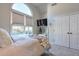 Serene bedroom with arched window and neutral color palette at 531 Sweetfern Ln, Sugar Hill, GA 30518