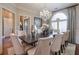 Formal dining room with a large table, chandelier, and hardwood floors at 531 Sweetfern Ln, Sugar Hill, GA 30518