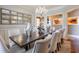 Formal dining room with a large table, chandelier, and hardwood floors at 531 Sweetfern Ln, Sugar Hill, GA 30518