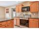 Kitchen with stainless steel appliances and oak cabinets at 531 Sweetfern Ln, Sugar Hill, GA 30518