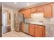 Kitchen with stainless steel appliances and oak cabinets at 531 Sweetfern Ln, Sugar Hill, GA 30518