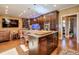 Open concept kitchen boasts a large island, ample cabinetry, and a built-in aquarium at 531 Sweetfern Ln, Sugar Hill, GA 30518