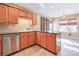 Kitchen with oak cabinets, stainless steel appliances, and tile backsplash at 531 Sweetfern Ln, Sugar Hill, GA 30518