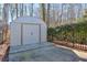 Tan metal storage shed with double doors at 531 Sweetfern Ln, Sugar Hill, GA 30518