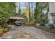 Carport with a single vehicle and mature trees at 610 Glenforest Rd, Sandy Springs, GA 30328