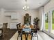 Kitchen dining area with hardwood floors, farmhouse table, and access to backyard at 8213 Bluewater Dr, Fairburn, GA 30213