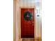 Red front door adorned with a lush green wreath, welcoming residents into their home at 10 Perimeter Summit Ne Blvd # 4315, Brookhaven, GA 30319