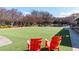 Expansive green lawn with two red Adirondack chairs at 10 Perimeter Summit Ne Blvd # 4315, Brookhaven, GA 30319