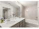 Double vanity bathroom with soaking tub and patterned tile at 4197 Spring Valley Cir, Tucker, GA 30084