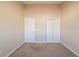 Simple bedroom with neutral walls and carpet, double door closet at 444 Kara Ln, Mcdonough, GA 30253