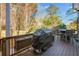 Back deck with grill, table, and chairs at 6733 Holiday Pt, Buford, GA 30518