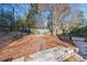 Private backyard with stone retaining wall and seating area at 6733 Holiday Pt, Buford, GA 30518