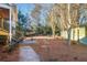 Landscaped backyard with pine straw and stone pathway at 6733 Holiday Pt, Buford, GA 30518