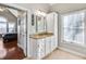 Bathroom with granite countertop, white cabinets, and a large mirror at 6733 Holiday Pt, Buford, GA 30518