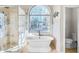 Elegant bathroom with soaking tub, shower, and separate toilet at 6733 Holiday Pt, Buford, GA 30518