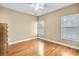 Bright bedroom with hardwood floors and two windows at 6733 Holiday Pt, Buford, GA 30518