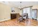 Hardwood floor dining room, featuring a chandelier and decorative wall art at 6733 Holiday Pt, Buford, GA 30518