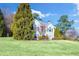 Two-story house with gray siding, red door, and landscaping at 6733 Holiday Pt, Buford, GA 30518