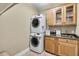 Convenient laundry room with washer, dryer, cabinets, and sink at 6733 Holiday Pt, Buford, GA 30518