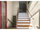 Wooden staircase with a red front door and glass panels at 6733 Holiday Pt, Buford, GA 30518