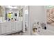 Double vanity bathroom with a soaking tub and white cabinets at 7977 Rudder Cir, Fairburn, GA 30213