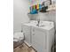 Laundry room with washer, dryer, and shelving at 7977 Rudder Cir, Fairburn, GA 30213