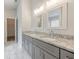 Double vanity bathroom with granite countertop at 9020 Amberly Way, Cumming, GA 30028