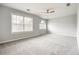 Bright bedroom with grey carpet and ceiling fan at 9020 Amberly Way, Cumming, GA 30028