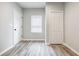 Bright bedroom with gray walls, vinyl flooring, and ample closet space at 9020 Amberly Way, Cumming, GA 30028