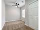 Simple bedroom with gray walls, carpet flooring, and ceiling fan at 9020 Amberly Way, Cumming, GA 30028