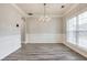 Elegant dining room with hardwood floors, wainscoting, and a chandelier at 9020 Amberly Way, Cumming, GA 30028